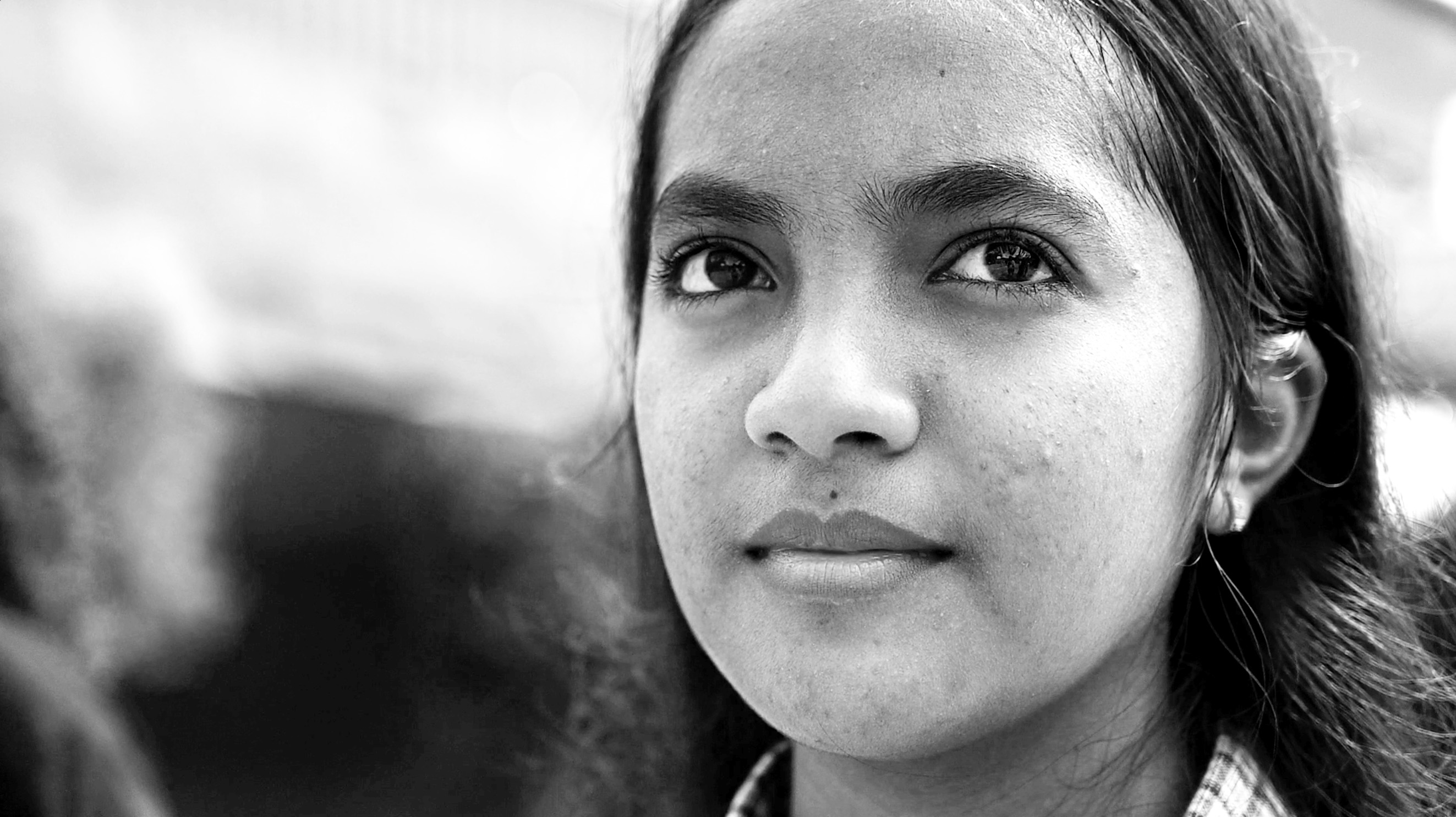 Young girl looking to the horizon, black and white photo