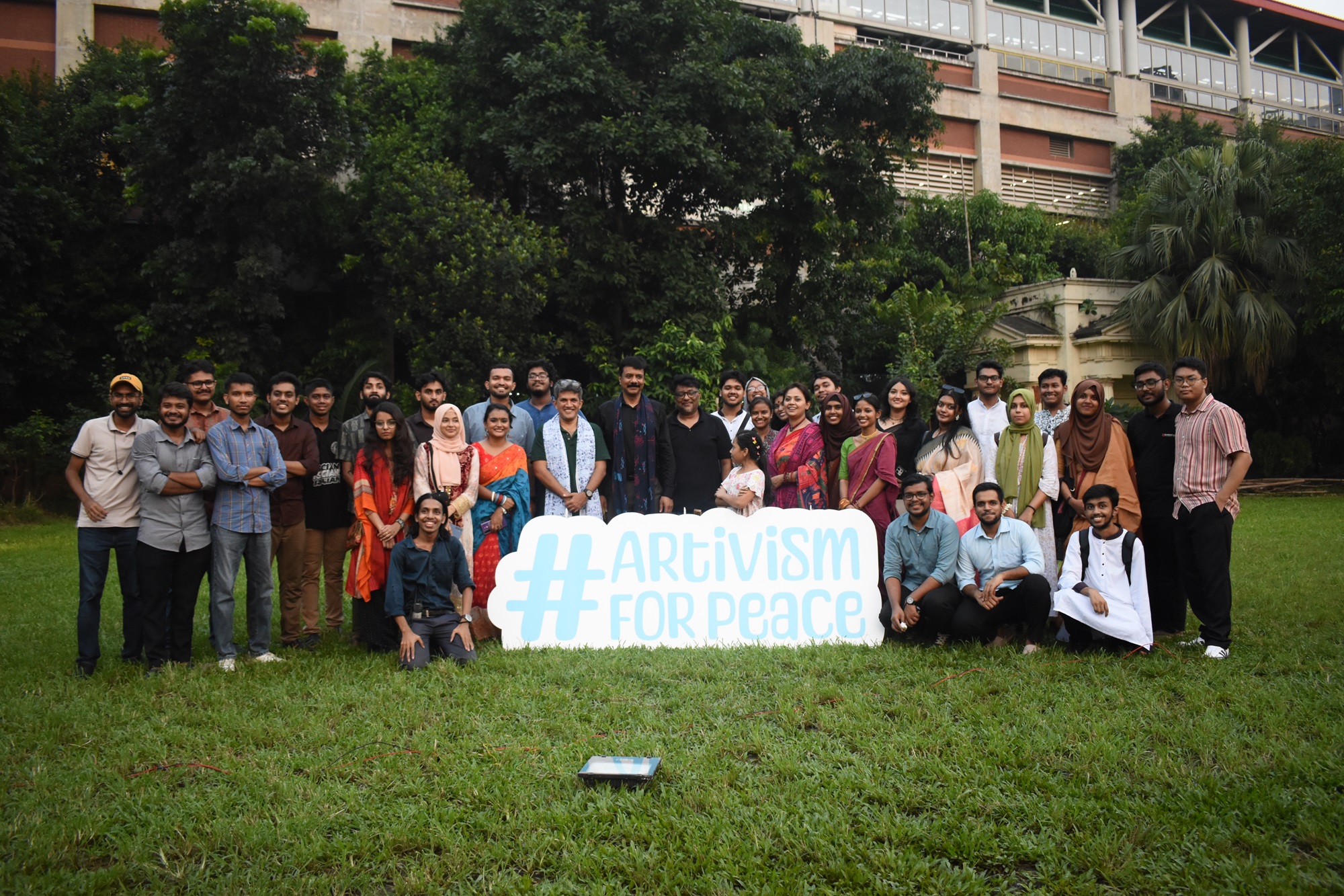 a group of people that are standing in the grass