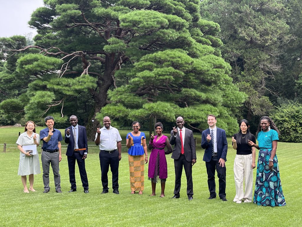 a group of people standing in a grassy field