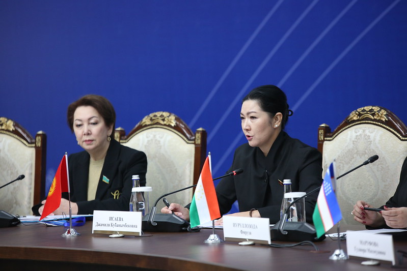 a group of people sitting at a desk