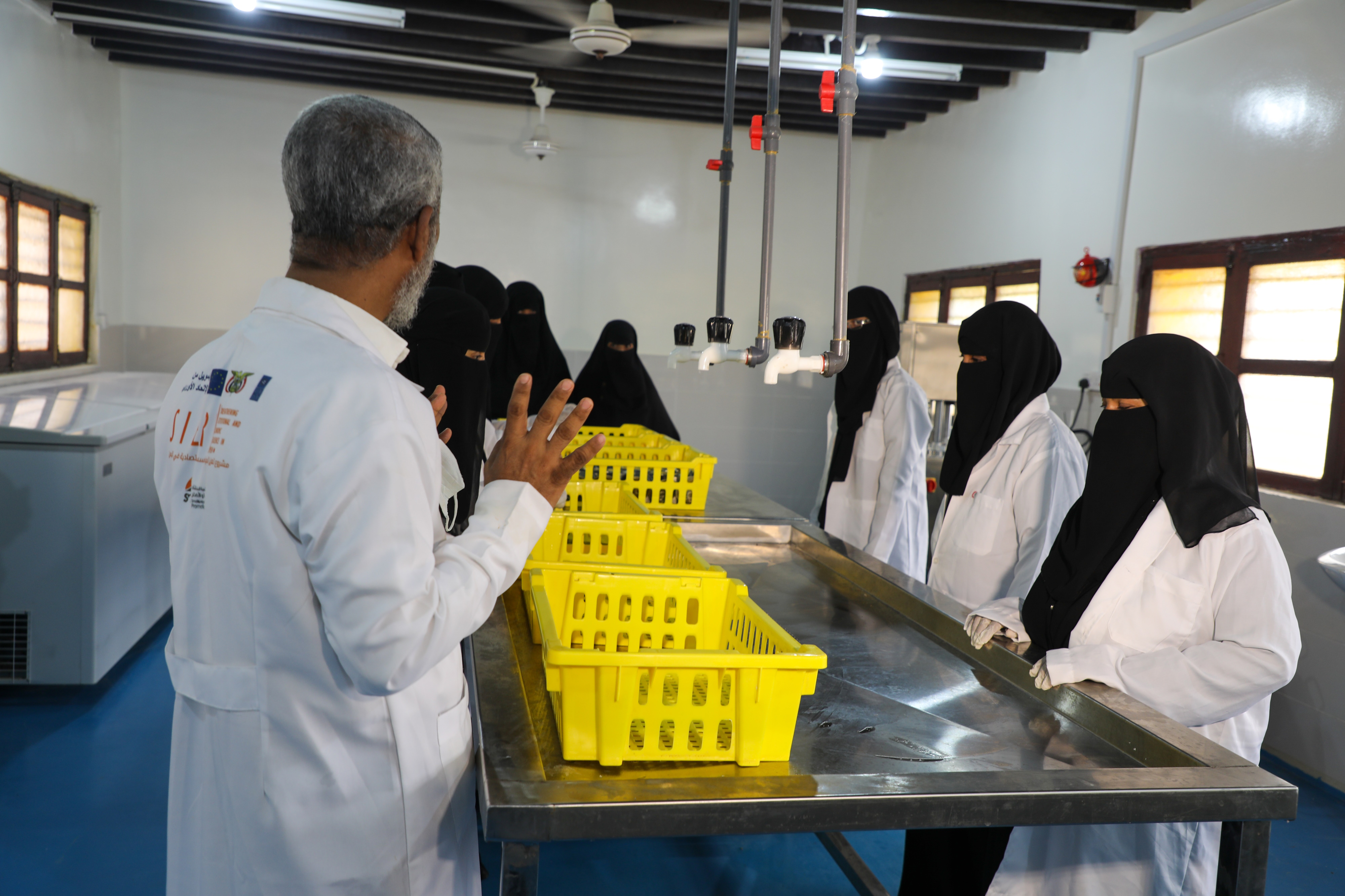 a man standing in a kitchen preparing food