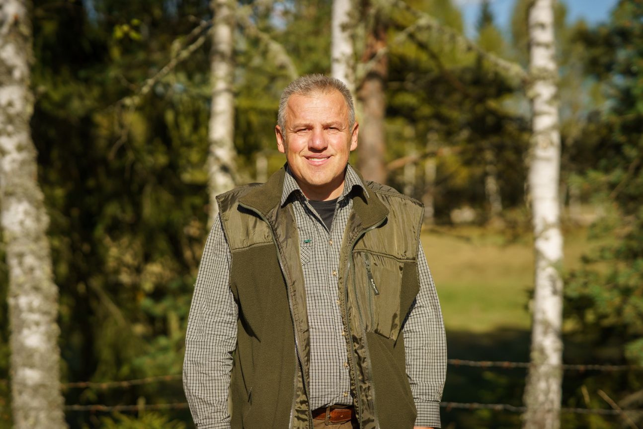 a man standing next to a tree