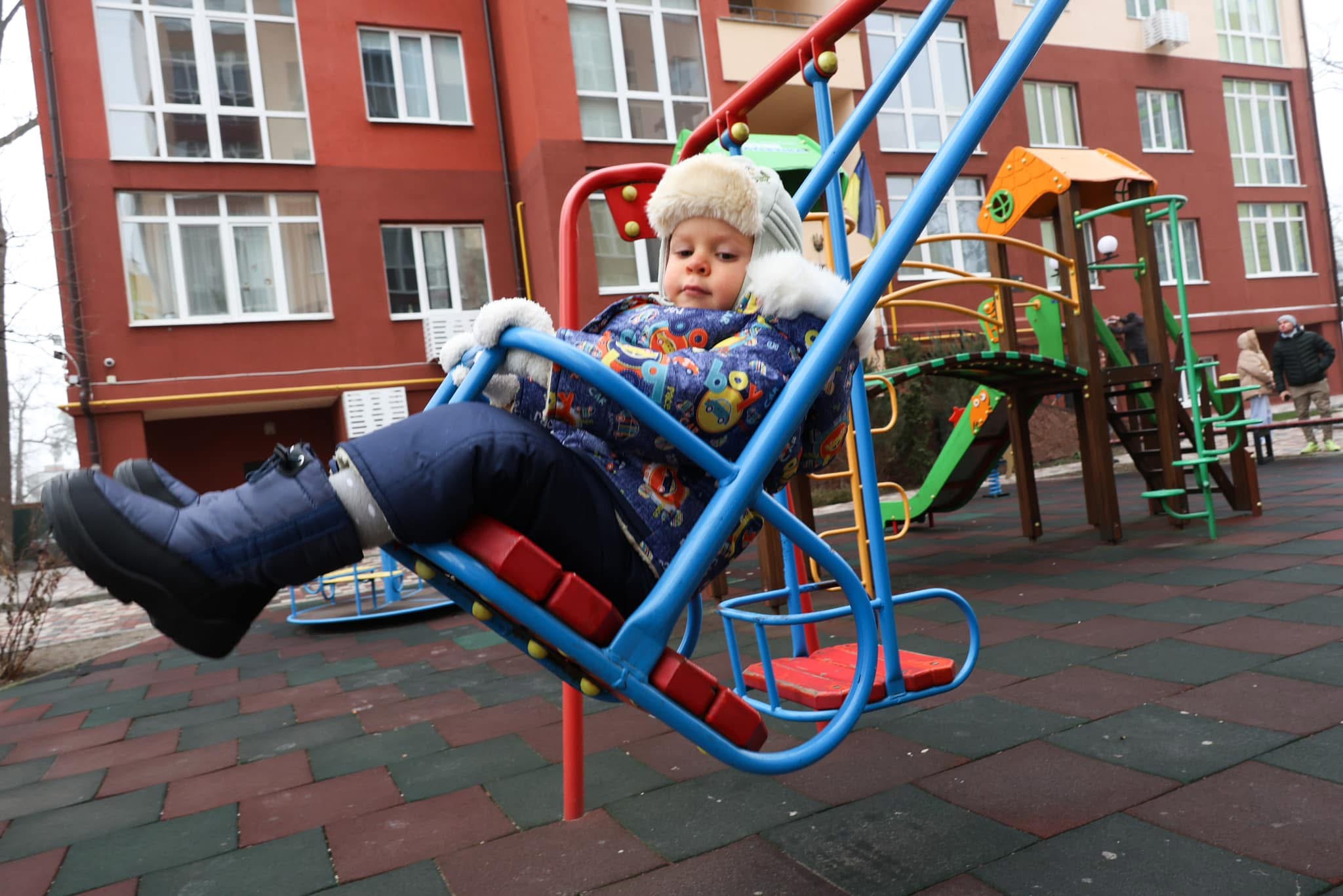 a small child sitting on a bench