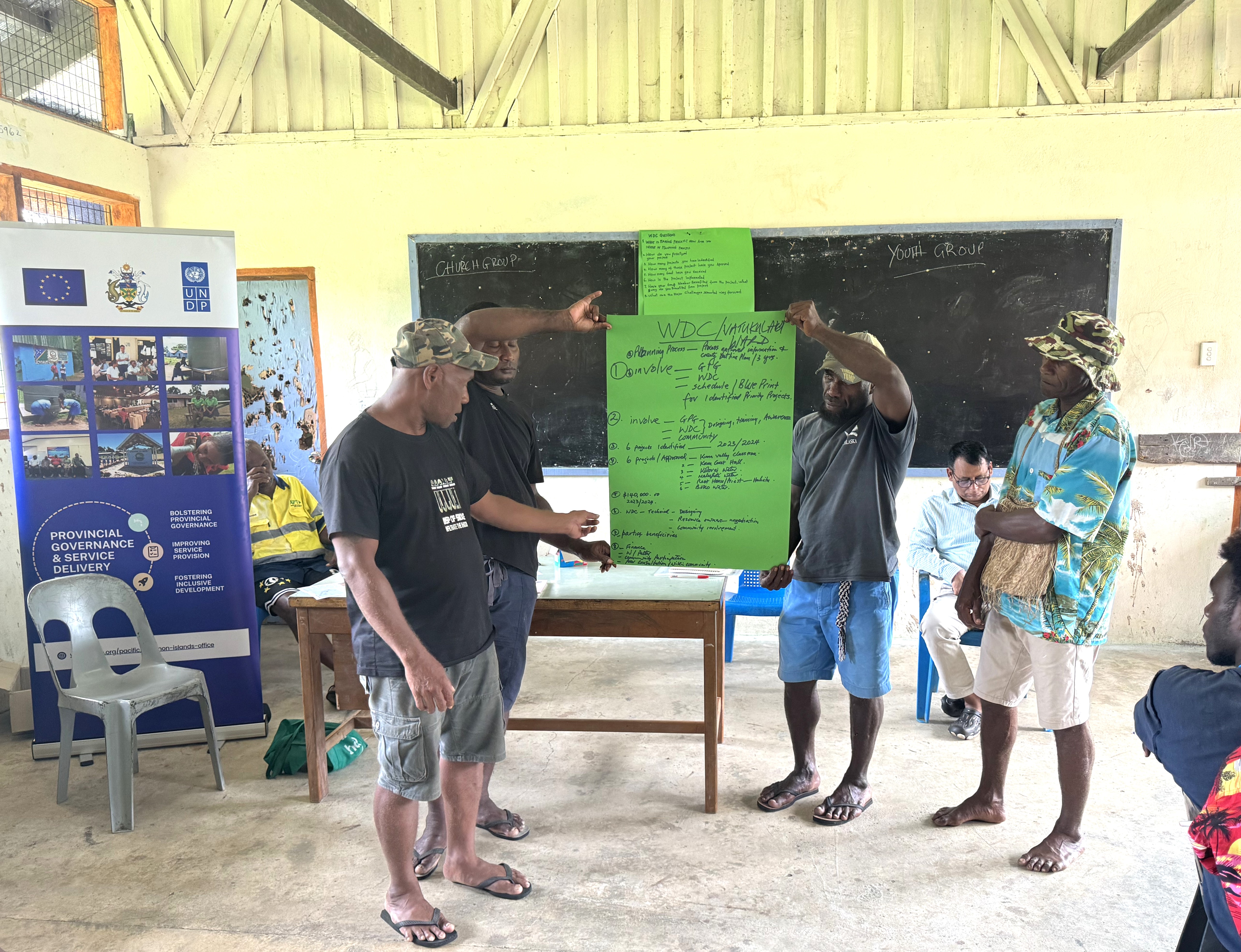 a group of people standing in front of a sign