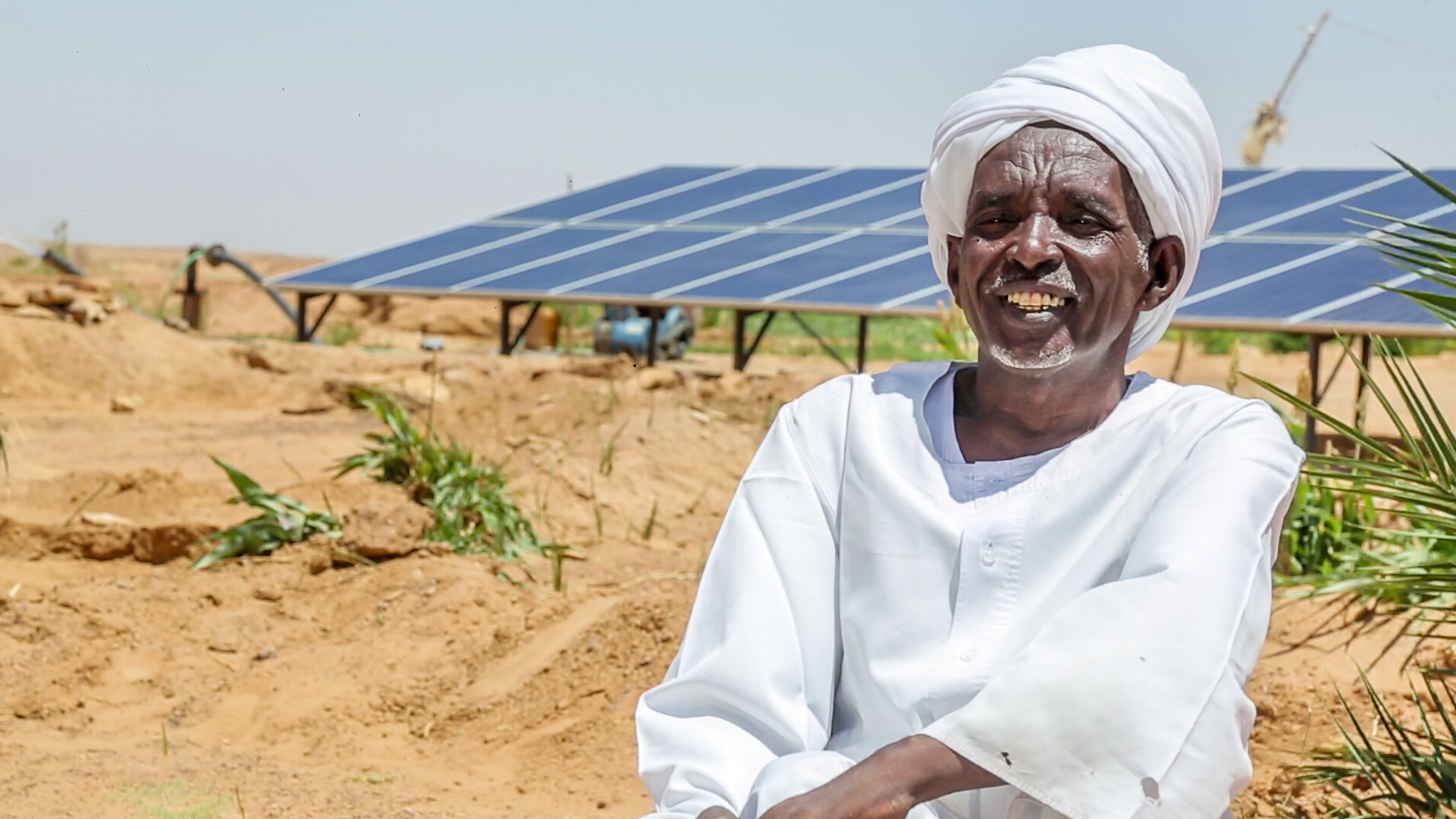 a person sitting near a solar panel