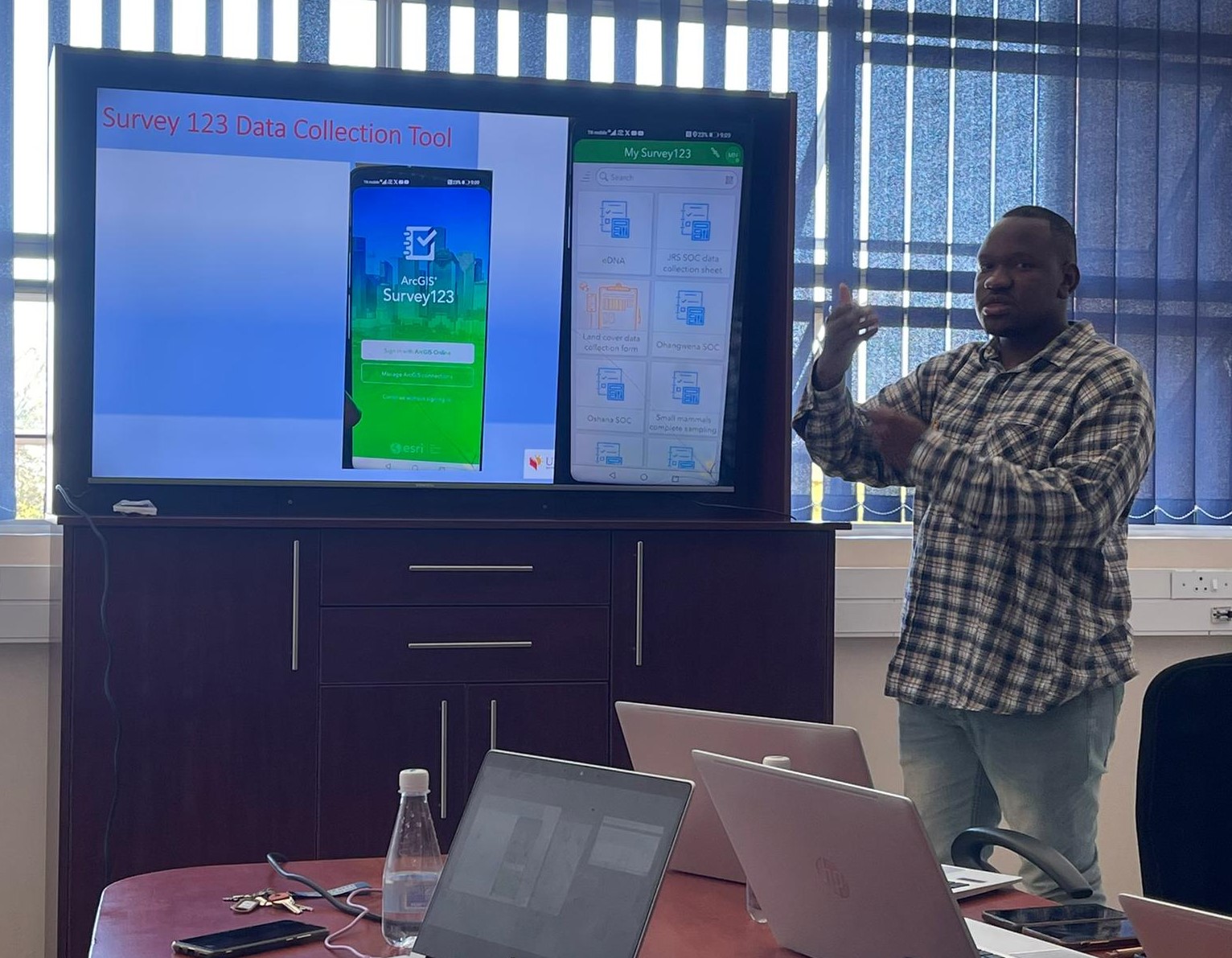 a person standing in front of a computer screen