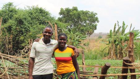 GEF-SGP Beneficiaries, Leonard Banda and Sabina Zulu standing in front of their farm