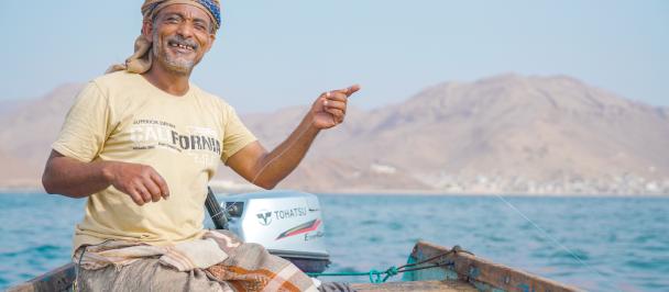 a man sitting on a boat in the water