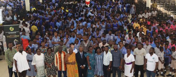 a group of people standing in front of a crowd posing for the camera